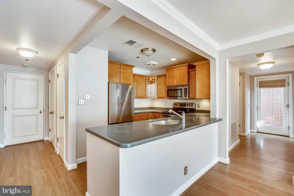 a kitchen with stainless steel appliances granite countertop a sink and refrigerator