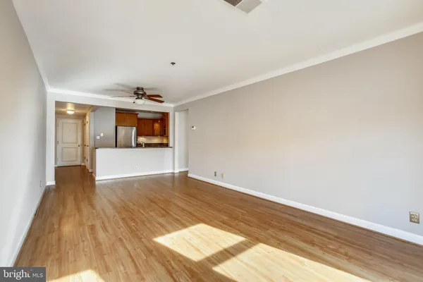 a view of a room with wooden floor and white walls