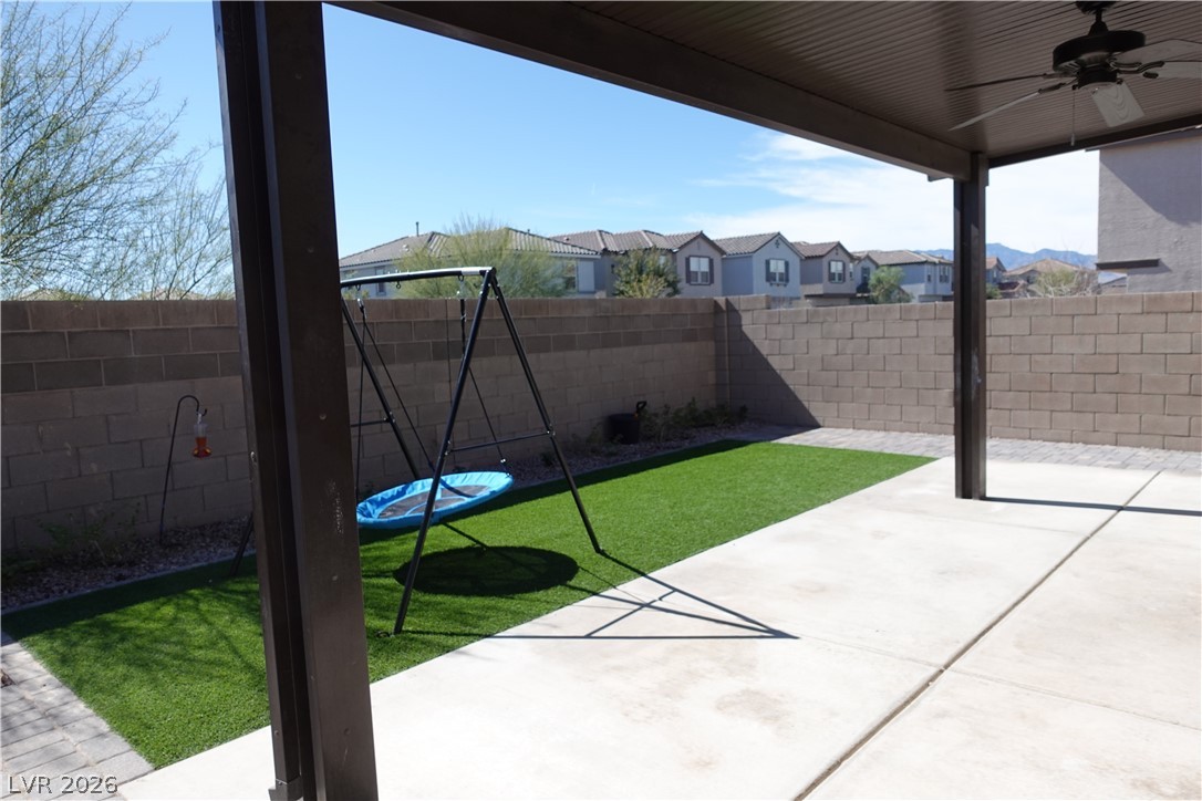 6959 Rancho Pk Court Las Vegas, NV 89113 - Photo 4 of 8 Fenced backyard featuring a patio area, ceiling fan, and a residential view