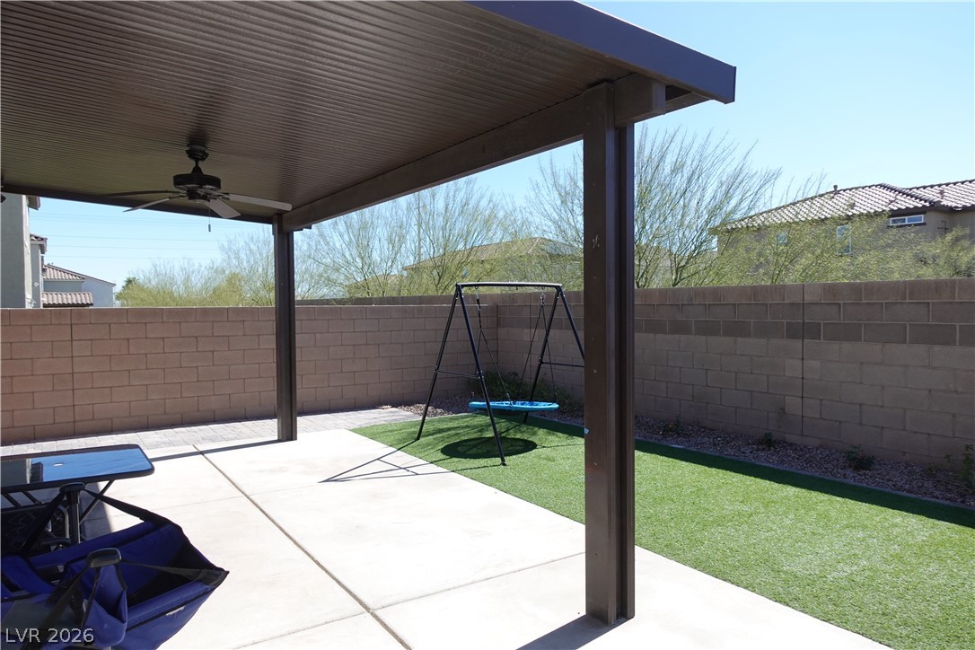 6959 Rancho Pk Court Las Vegas, NV 89113 - Photo 5 of 8 Fenced backyard featuring a ceiling fan, a patio area, and a trampoline
