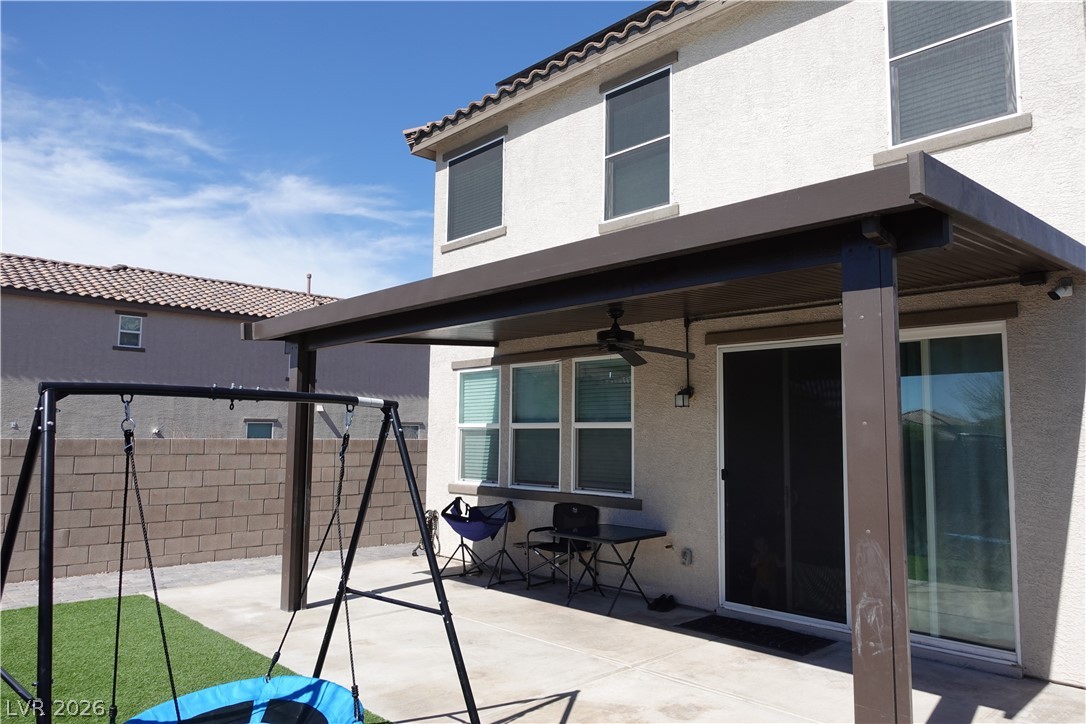 6959 Rancho Pk Court Las Vegas, NV 89113 - Photo 7 of 8 Rear view of house with a patio, ceiling fan, and stucco siding