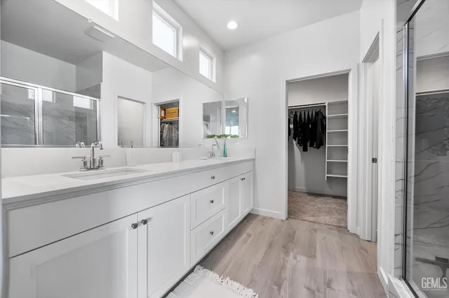 a spacious bathroom with a double vanity sink and a mirror