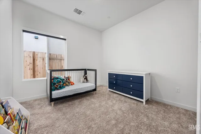 an empty room with window and dresser