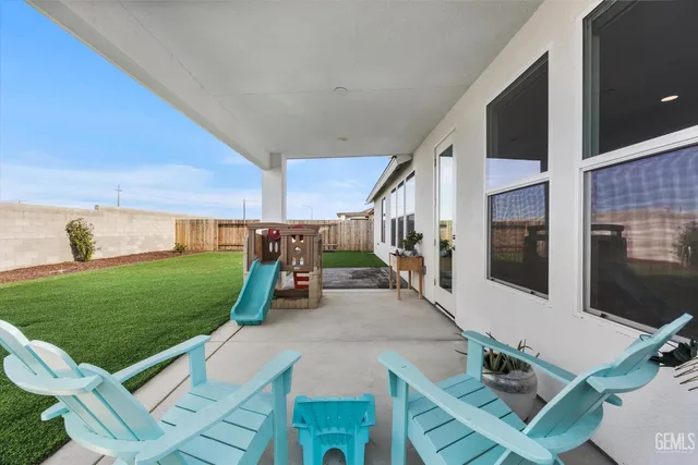 a view of a porch with furniture and garden