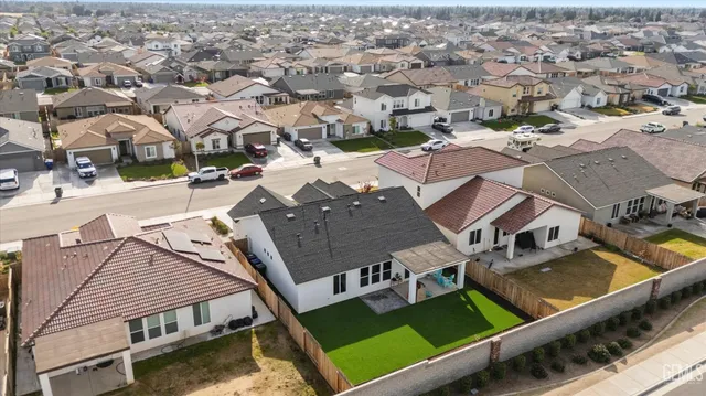 an aerial view of residential houses with yard