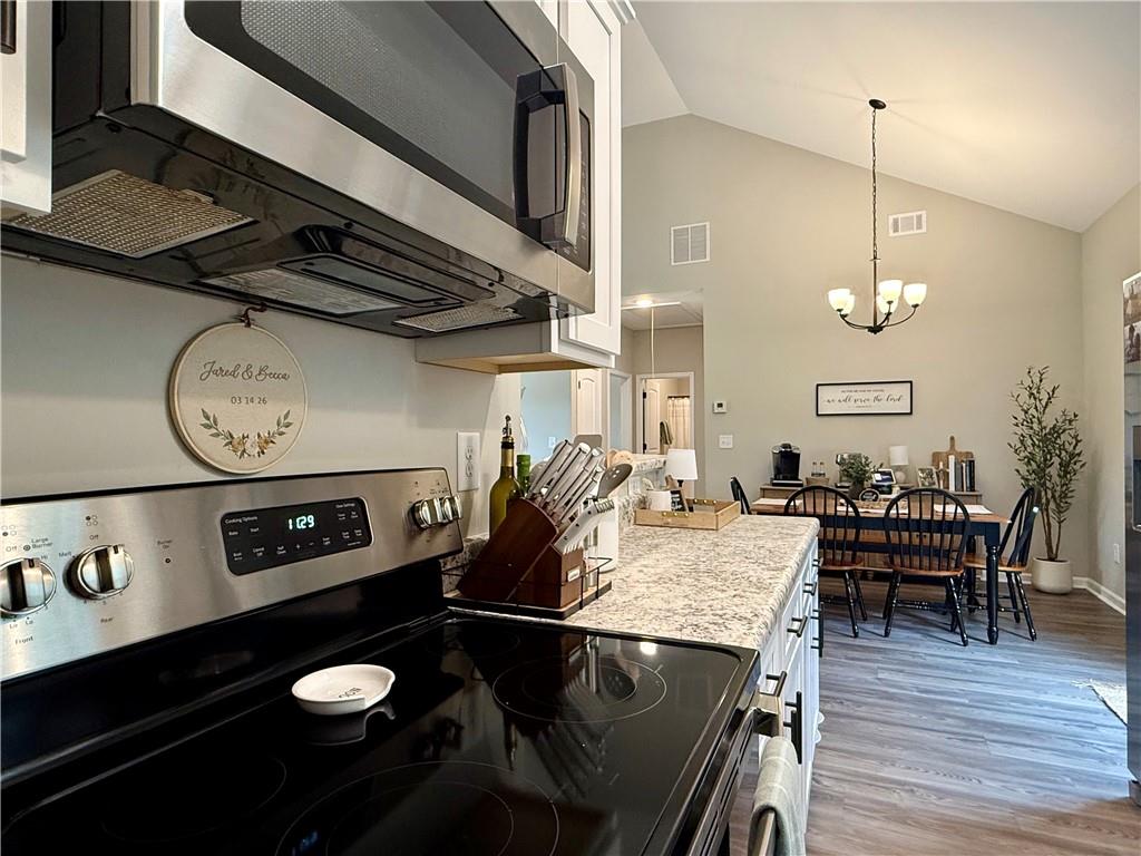 1776 Pleasant Grove Road Temple, GA 30179 - Photo 12 of 45 a kitchen with a table chairs and stove