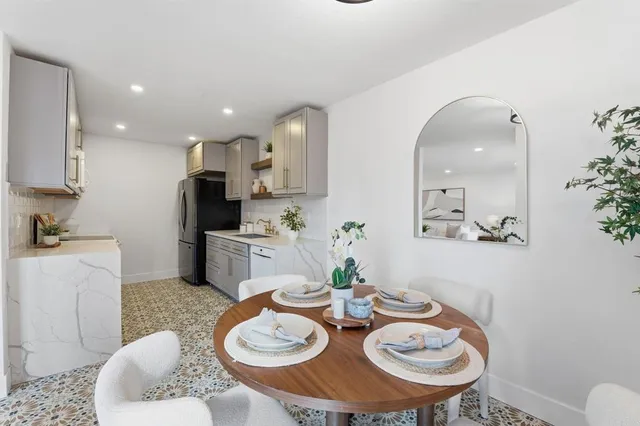 a view of a dining room with furniture and wooden floor