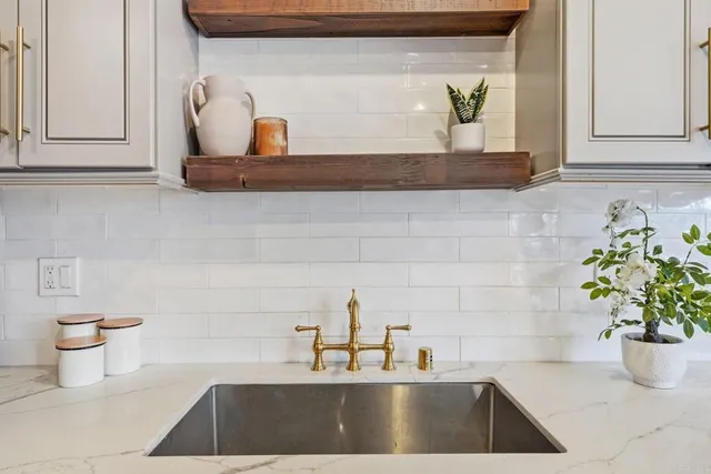 a kitchen with stainless steel appliances granite countertop a sink a refrigerator a stove a microwave and cabinets