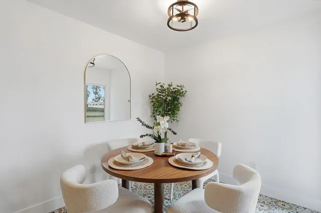 a kitchen with a dining table and chairs
