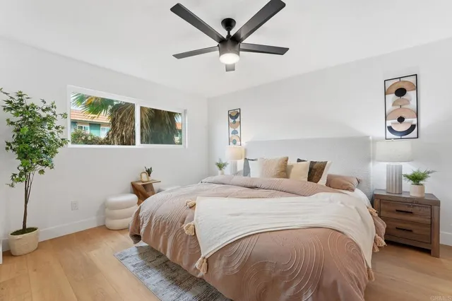 a bedroom with bed and a chandelier