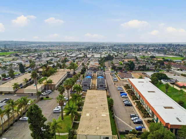 an aerial view of a residential apartment building with a yard