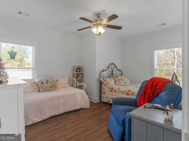 a bedroom with furniture and a large window