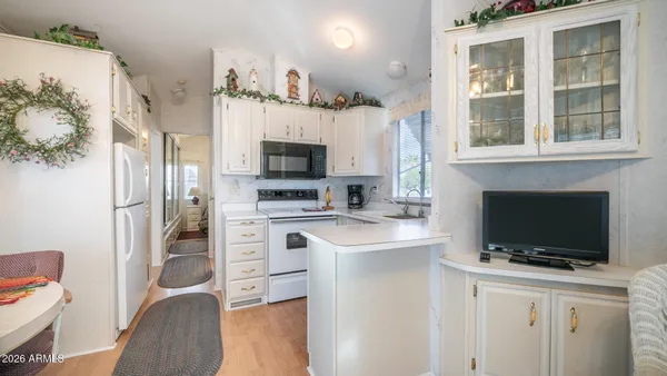 a kitchen with cabinets appliances a sink and a window