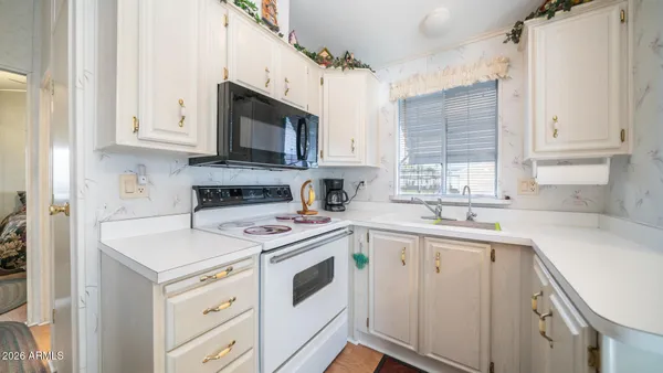 a bed room with a bed and a painting on the wall