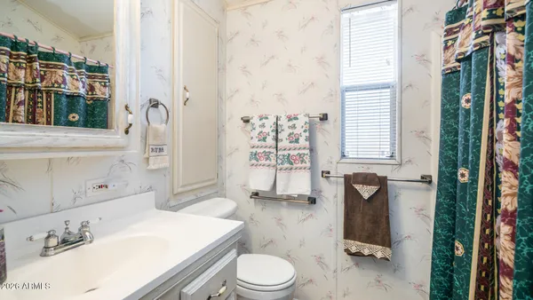 a living room with furniture a fireplace and a chandelier