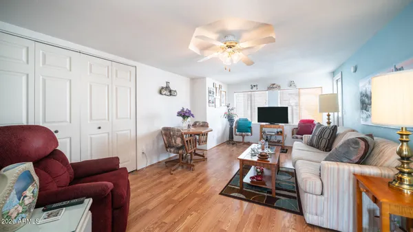 a living room with furniture flowers and a fireplace