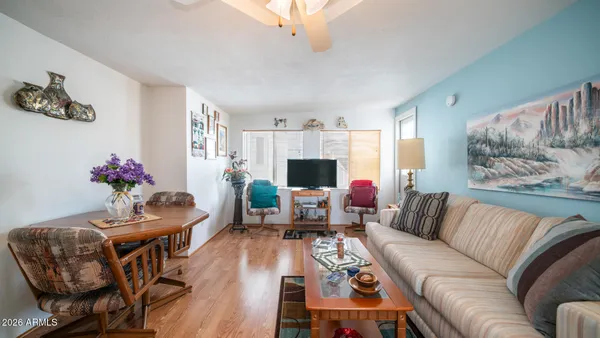 a living room with furniture and flowers