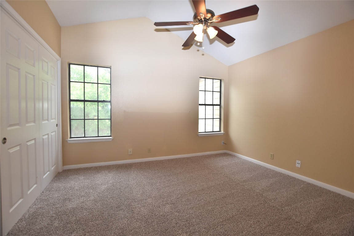 11404 Walnut Ridge Drive, Unit 14 Austin, TX 78753 - Photo 11 of 16 an empty room with windows and fan