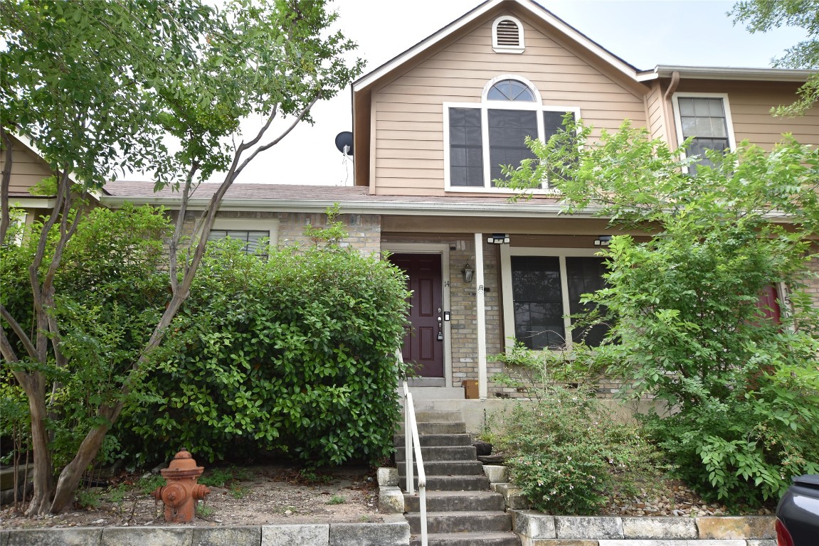 11404 Walnut Ridge Drive, Unit 14 Austin, TX 78753 - Photo 2 of 16 a front view of a house with plants