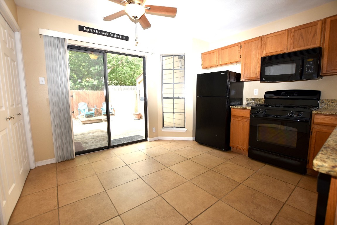 11404 Walnut Ridge Drive, Unit 14 Austin, TX 78753 - Photo 6 of 16 a view of a kitchen with a stove fridge and wooden floor