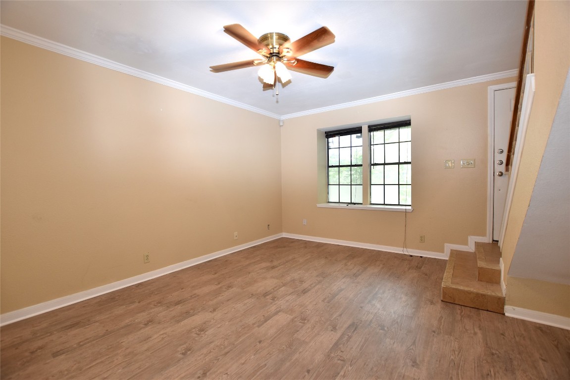11404 Walnut Ridge Drive, Unit 14 Austin, TX 78753 - Photo 7 of 16 an empty room with wooden floor and windows
