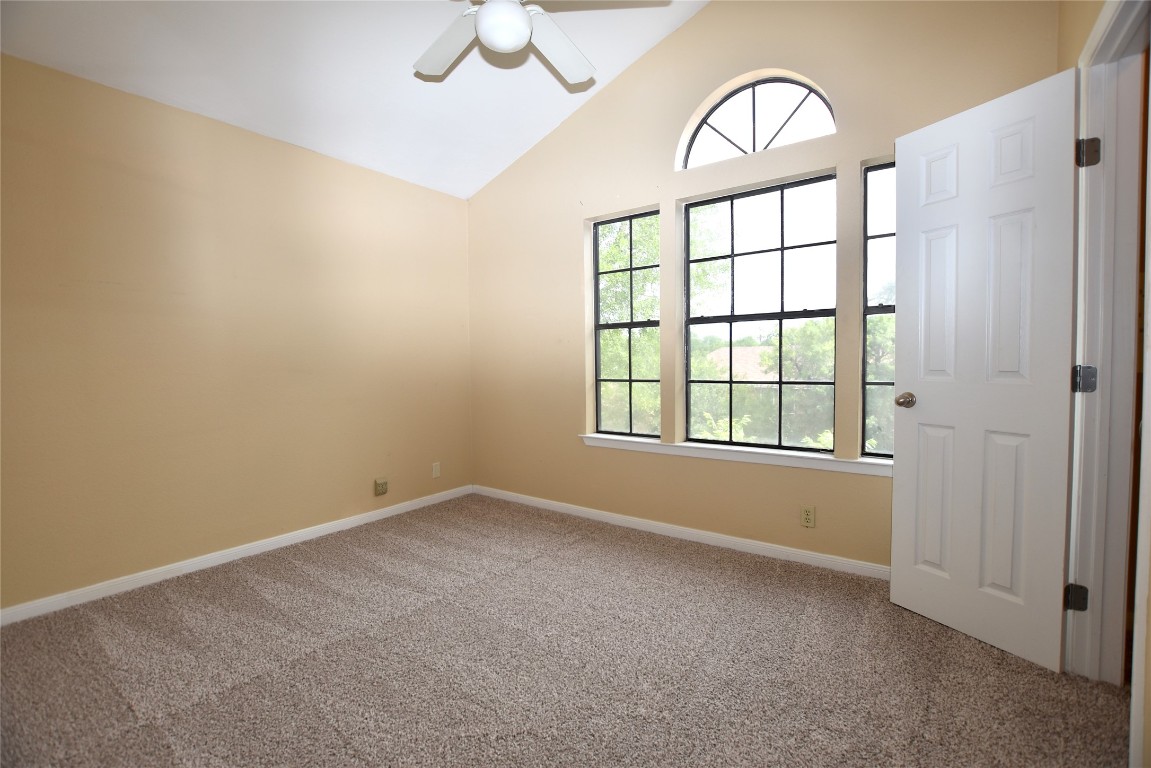 11404 Walnut Ridge Drive, Unit 14 Austin, TX 78753 - Photo 9 of 16 an empty room with windows and fan