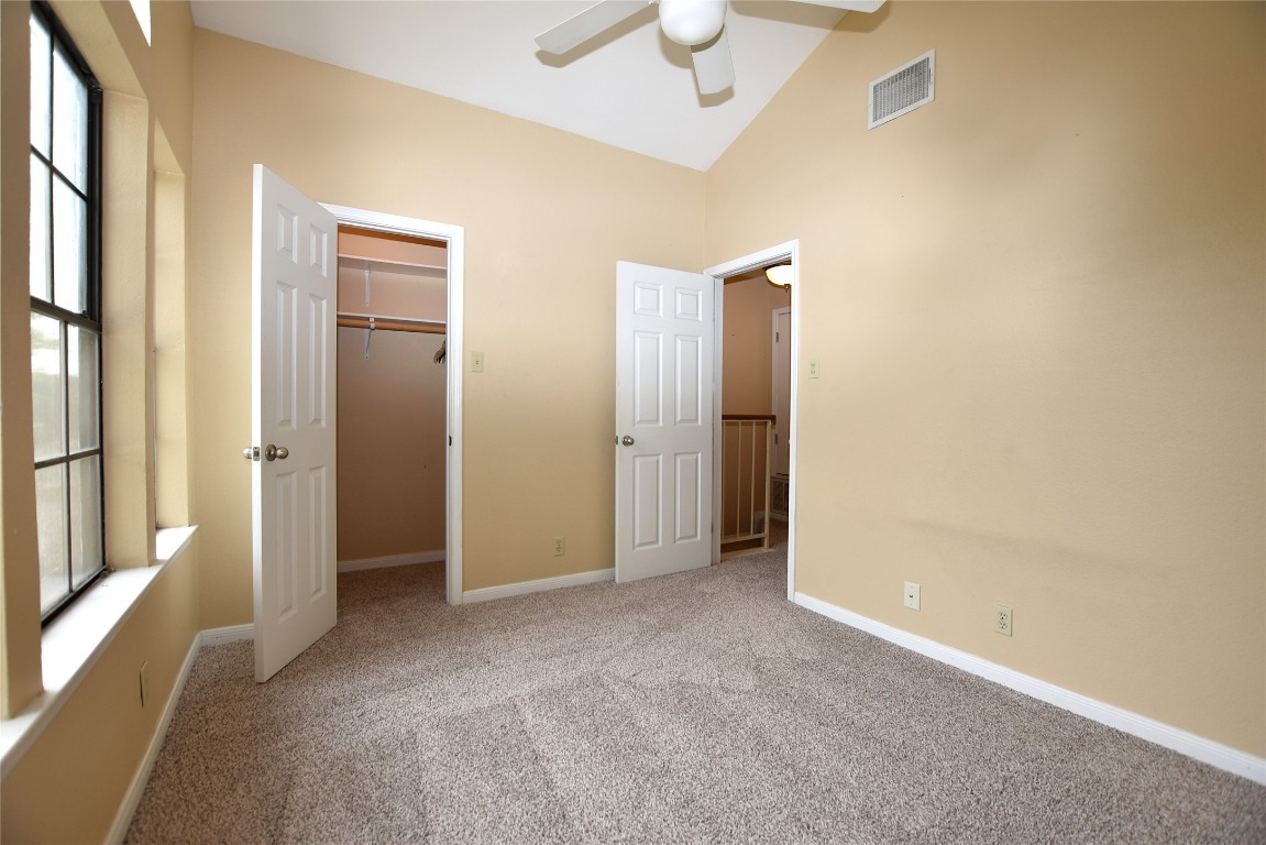11404 Walnut Ridge Drive, Unit 14 Austin, TX 78753 - Photo 10 of 16 an empty room with closet and a chandelier fan