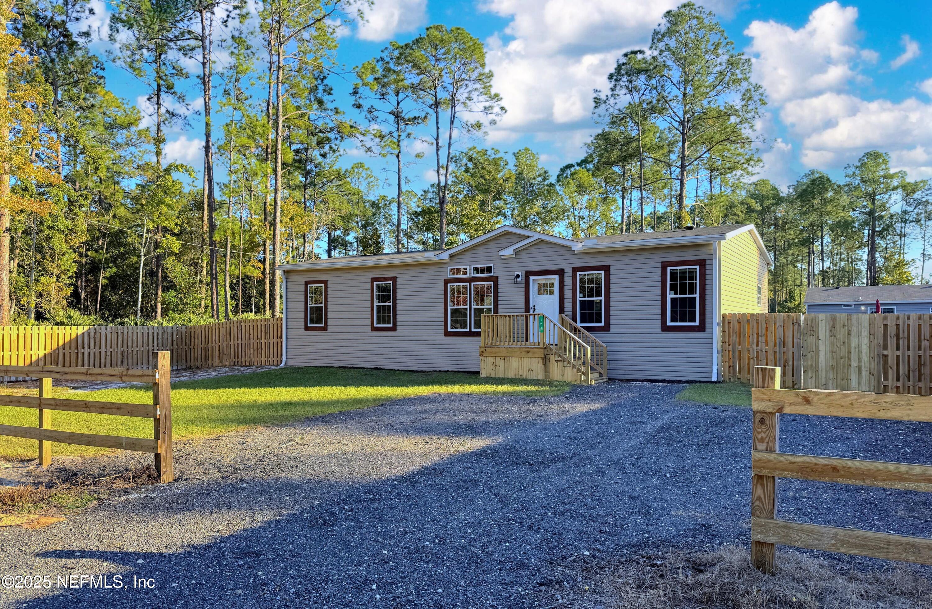 127 Domingo Road Satsuma, FL 32189 - Photo 1 of 18 a view of a house with backyard and trees