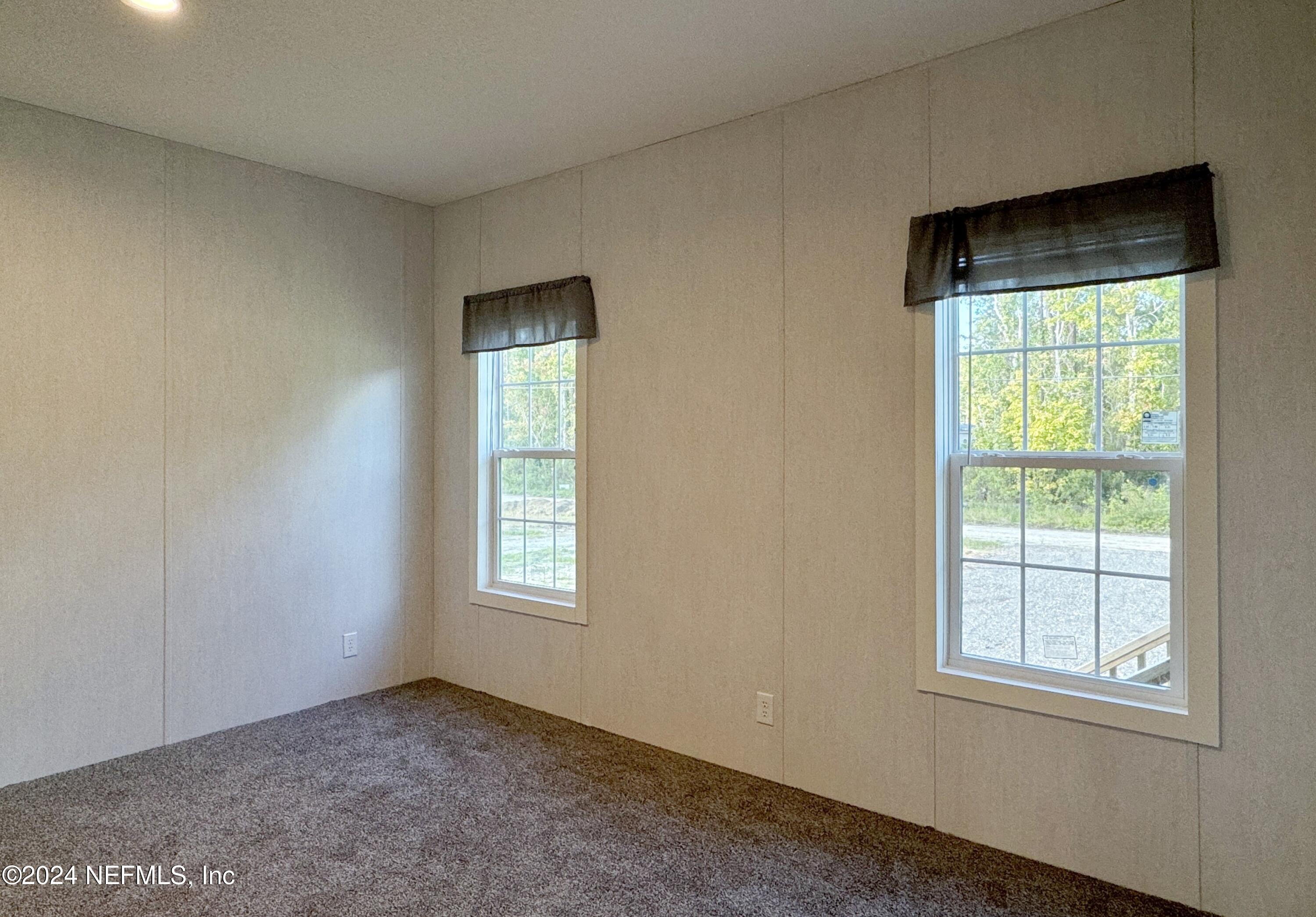 127 Domingo Road Satsuma, FL 32189 - Photo 11 of 18 an empty room with windows and closet