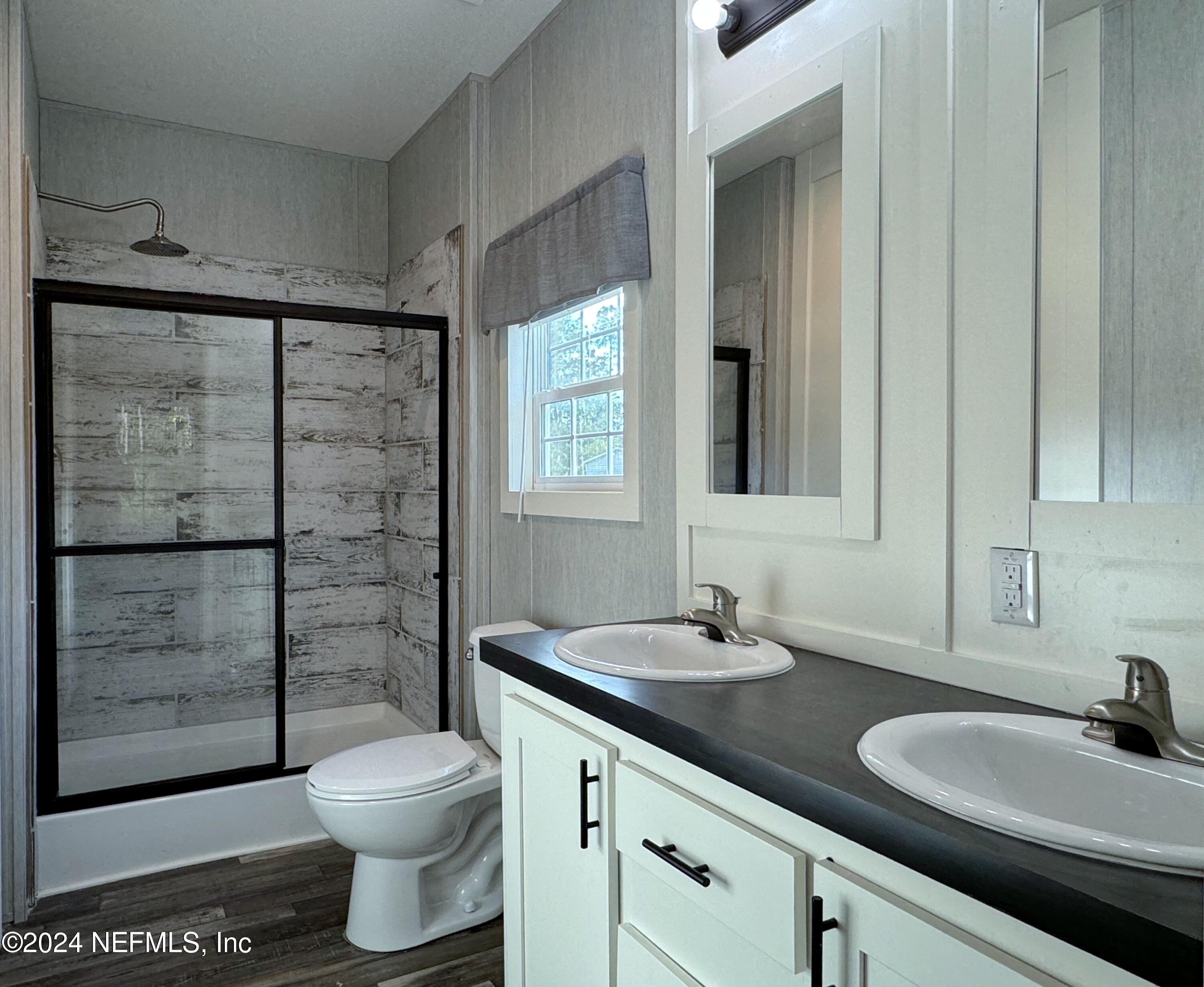 127 Domingo Road Satsuma, FL 32189 - Photo 13 of 18 a bathroom with a sink a toilet and shower