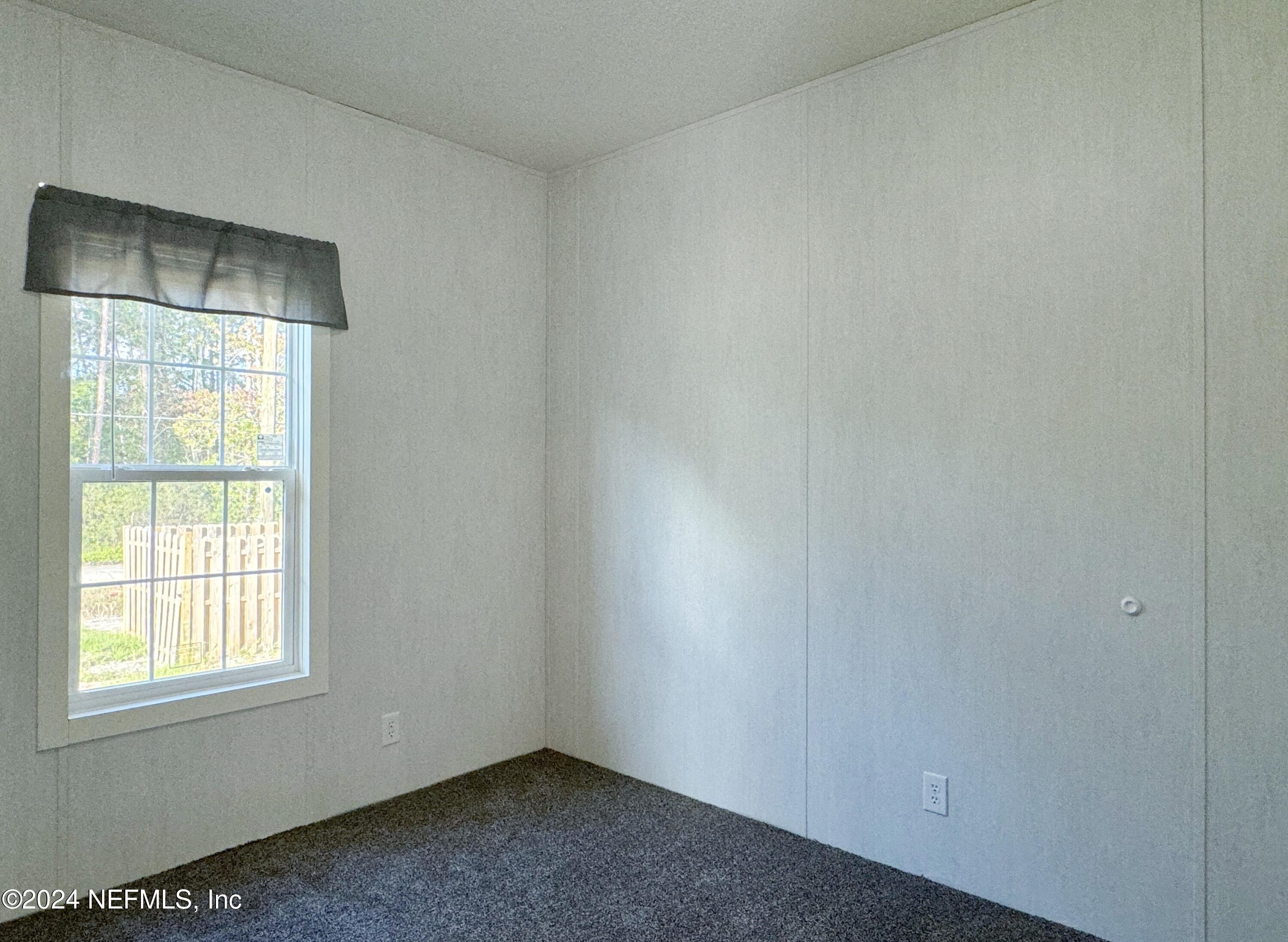 127 Domingo Road Satsuma, FL 32189 - Photo 15 of 18 an empty room with a empty space and windows