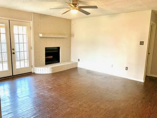a view of a livingroom with a fireplace and wooden floor