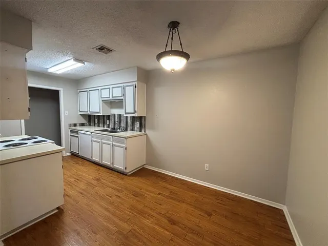 a view of an empty room and wooden floor