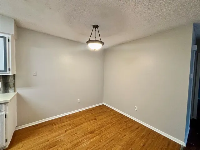 an empty room with closet and a ceiling fan