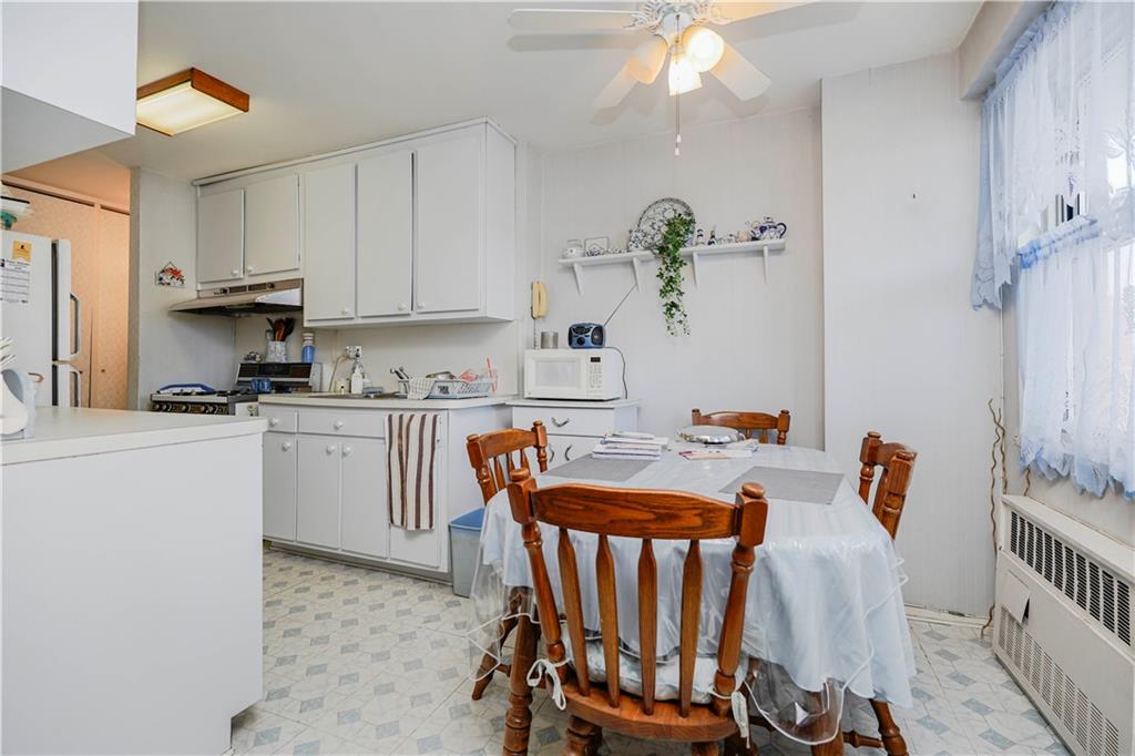 2475 West 16th Street, Unit 4K Brooklyn, NY 11214 - Photo 11 of 15 a kitchen with a refrigerator and white cabinets