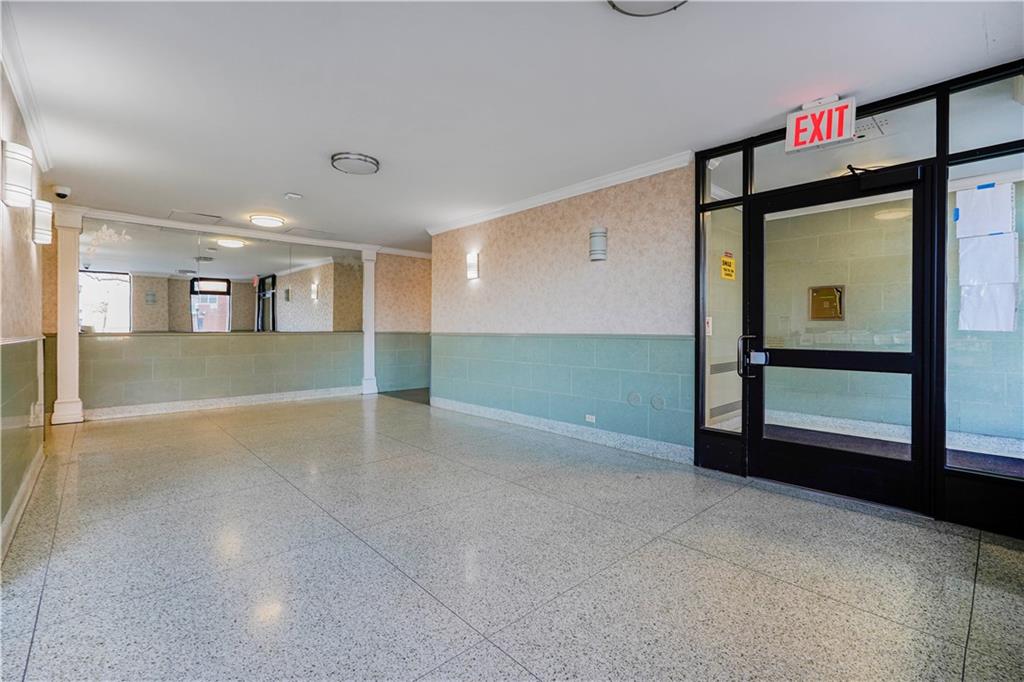 2475 West 16th Street, Unit 4K Brooklyn, NY 11214 - Photo 2 of 15 a view of a hallway with wooden floor and a fireplace