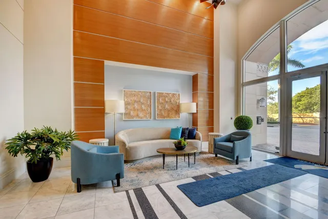 a living room with furniture and potted plant