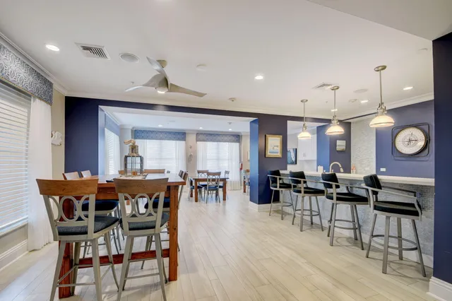 a view of a dining room with furniture and chandelier