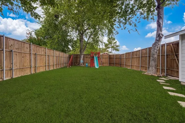 a view of a backyard with a large tree