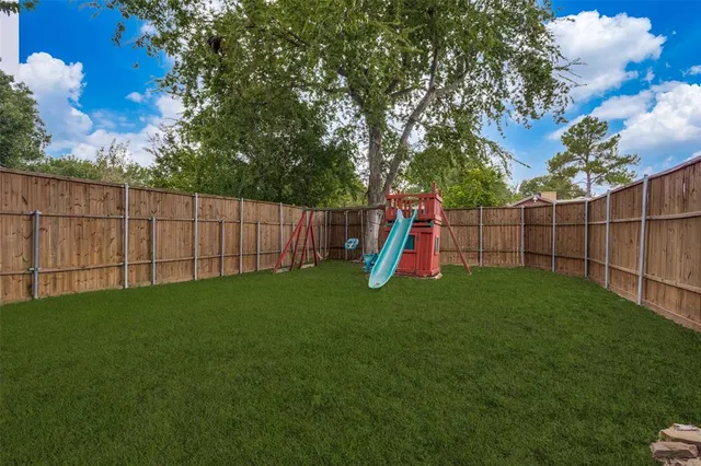 a view of a backyard with a trampoline