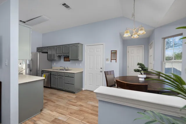 a kitchen with a sink stove and refrigerator