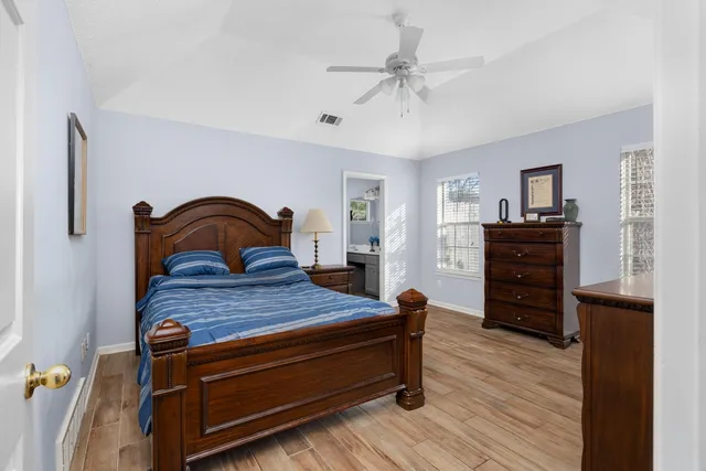 a bedroom with a bed and wooden floor