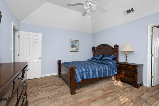 a bedroom with a bed and a chandelier