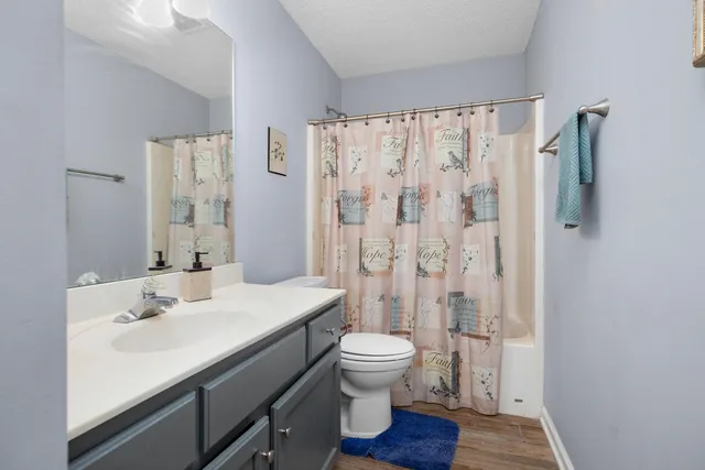 a bathroom with a sink a toilet a shower and a mirror