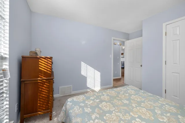 a view of room with window and wooden floor