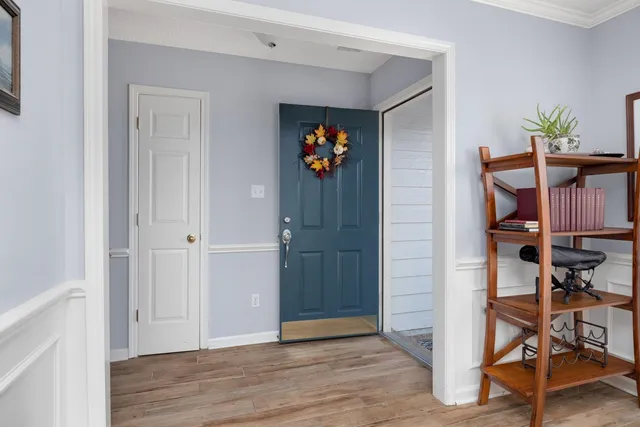 a view of an entryway with wooden floor