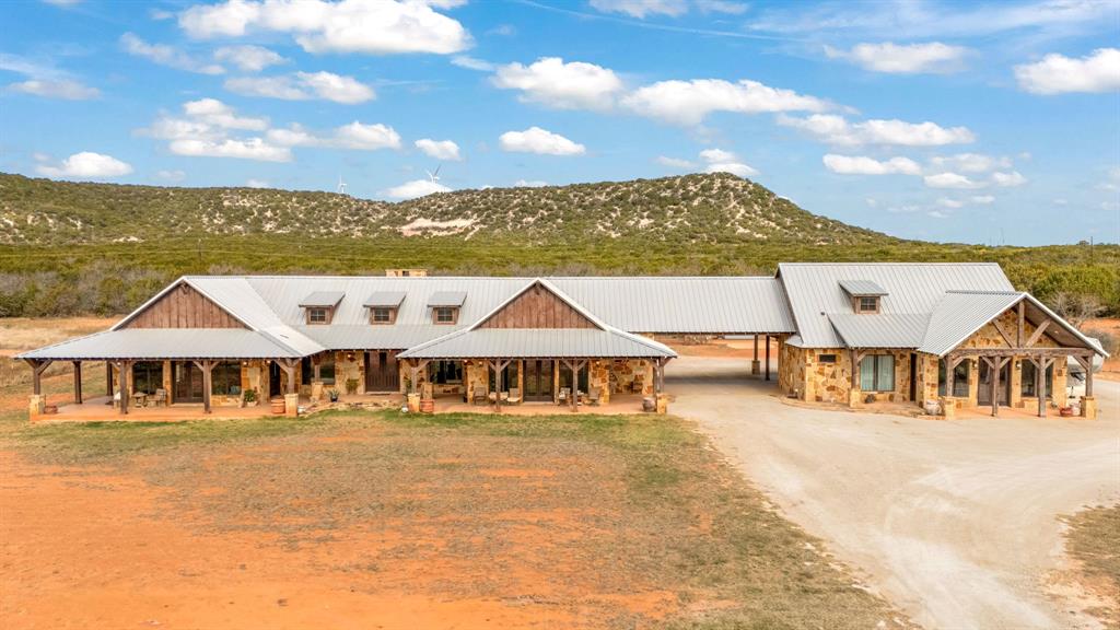 a front view of house with yard and swimming pool