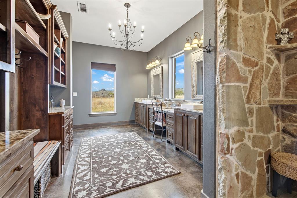 650 Fm 2035 Merkel, TX 79536 - Photo 19 of 40 a spacious bathroom with a double vanity sink a mirror a bathtub and next to a window