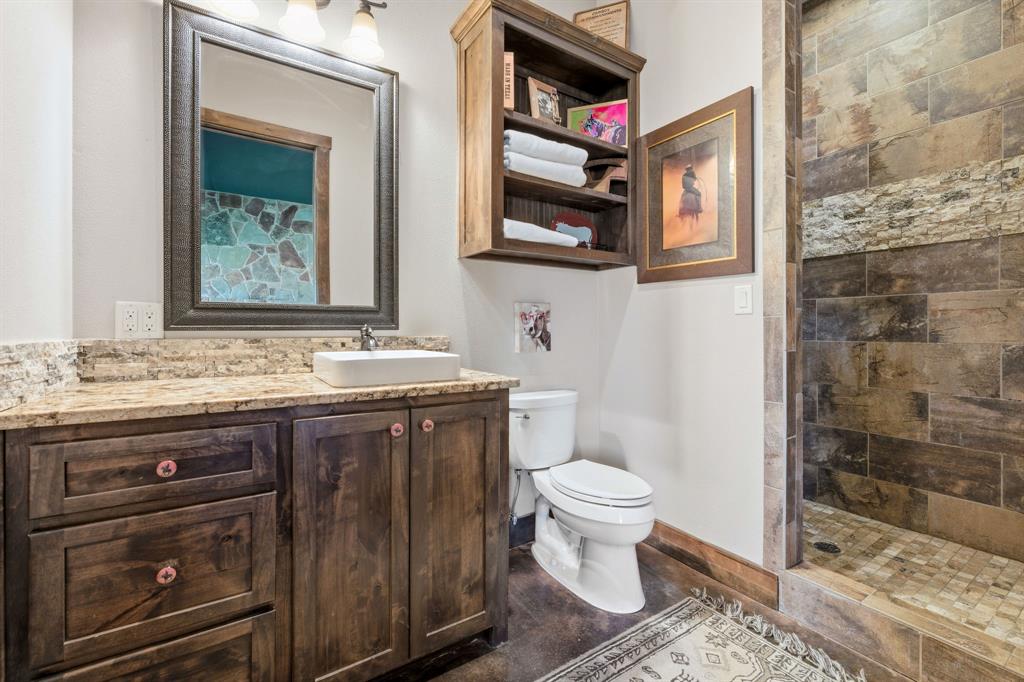 650 Fm 2035 Merkel, TX 79536 - Photo 26 of 40 a bathroom with a granite countertop toilet sink and mirror