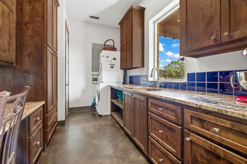 650 Fm 2035 Merkel, TX 79536 - Photo 28 of 40 a kitchen with granite countertop a sink stove and cabinets